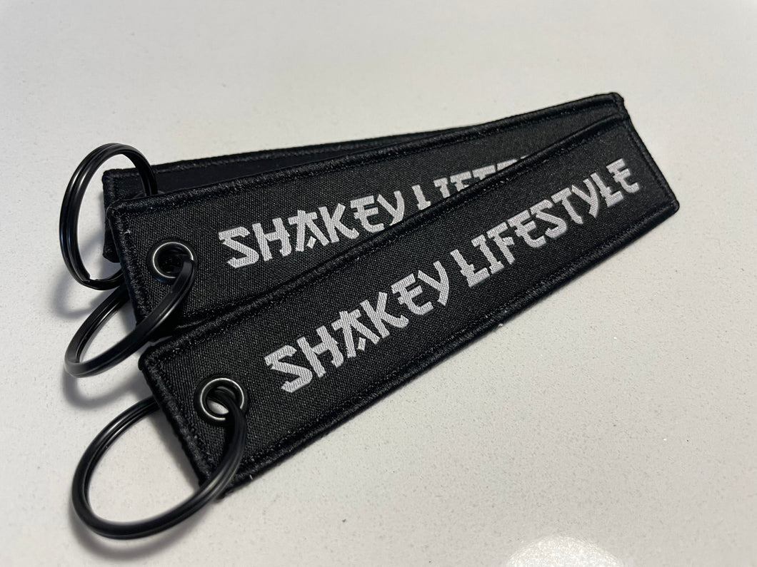 SHAKEY LIFESTYLE BLACK FLIGHT TAG